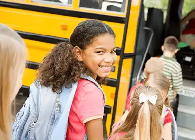 Girl getting on bus